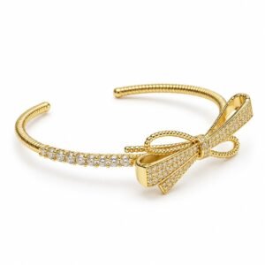 Pulsera rígida dorada con lazo de circonias